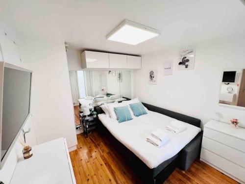 a small room with a bed and a sink at Iconic location only 500 meters to The Louvre in Paris