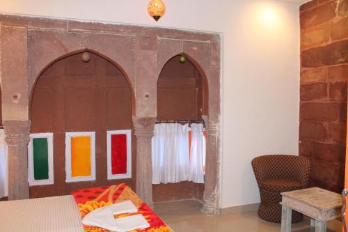 a room with two arched doors and a bed at Karma Heritage Guest House in Jodhpur