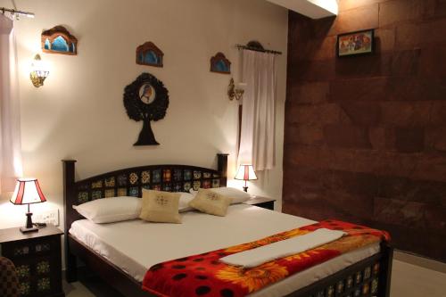 a bedroom with a bed with two towels on it at Karma Heritage Guest House in Jodhpur