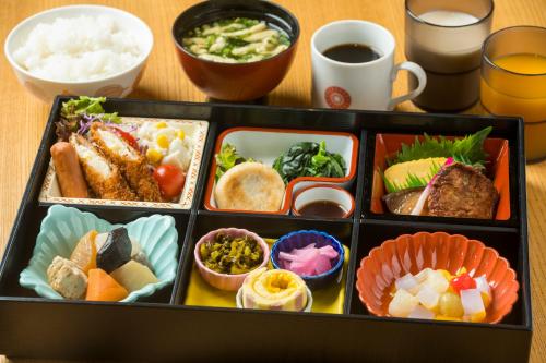 a tray filled with different types of food on a table at KOKO HOTEL Kagoshima Tenmonkan in Kagoshima