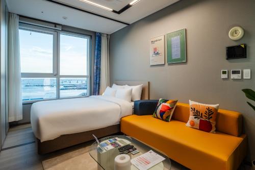 釜山的住宿－Radiant Nampo Hotel，酒店客房设有一张大床和一张沙发。