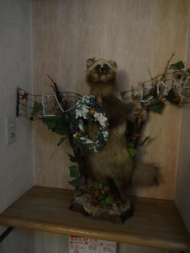 a painting of a bear holding flowers on a shelf at Highland Lodge Takegen in Myoko