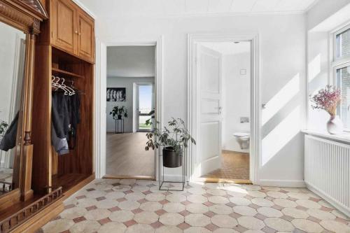a hallway with a toilet and a potted plant at Lovely Farmhouse For The Whole Family in Slagelse