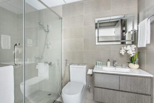 a bathroom with a shower and a toilet and a sink at Frank Porter - Bella Rose in Dubai
