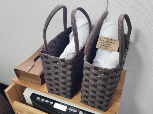 two baskets sitting on top of a shelf at Pension Kobekko in Otari