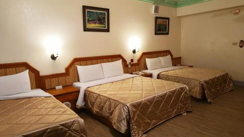 a hotel room with two beds in a room at Longchi Hot-Spring Hotel in Jiaoxi