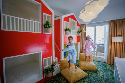 two children playing in a room with beds at Rixos Bab Al Bahr - Ultra All Inclusive in Ras al Khaimah