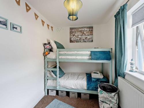 a childs bedroom with bunk beds in a room at 4 Bed in Combe Martin 83502 in Combe Martin
