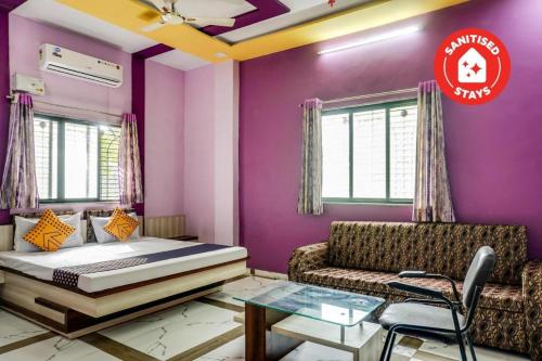 a bedroom with a bed and a couch at Hotel Anupark in Sakri