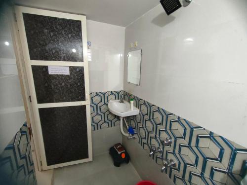 a bathroom with a sink and a mirror at My Nest - Best Homestay for Peaceful Stay with Comfort in Bhuj