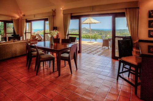 a dining room with a table and chairs with a view at Villa Alpha - Seaview Private Villa in Choeng Mon Beach