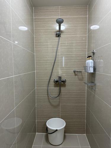 a bathroom with a shower with a toilet in it at 1BR BGC Uptown Modern Condo Netflix 200Mb Wifi in Manila
