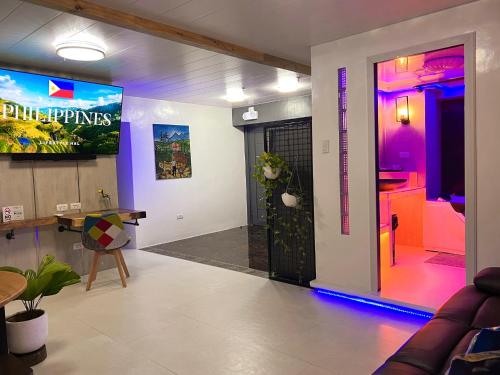a living room with a video game on the wall at CLOCKWORKORANGE Luxury Suites 4-Minutes Away To Airport in Mactan