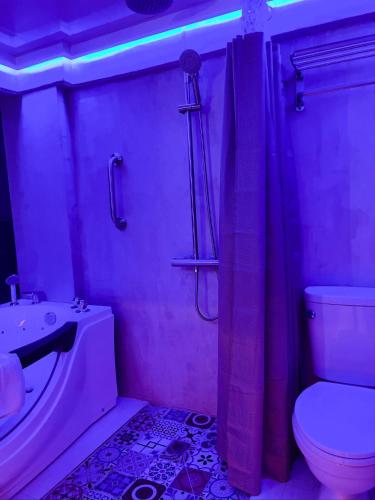 a bathroom with a tub and a toilet and a sink at CLOCKWORKORANGE Luxury Suites 4-Minutes Away To Airport in Mactan