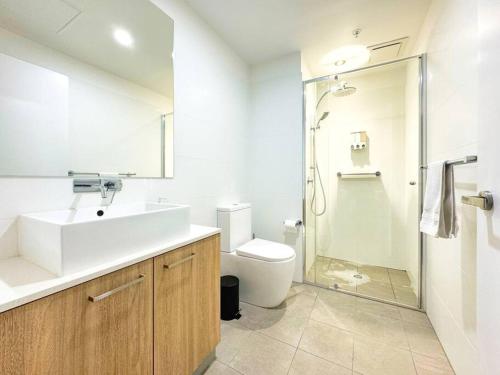 a bathroom with a sink and a toilet and a shower at Urban Sanctuary in West Franklin with Pool & Gym in Adelaide