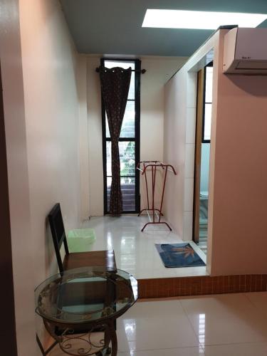 a room with a glass table and a chair at Nature Home in Phra Nakhon Si Ayutthaya