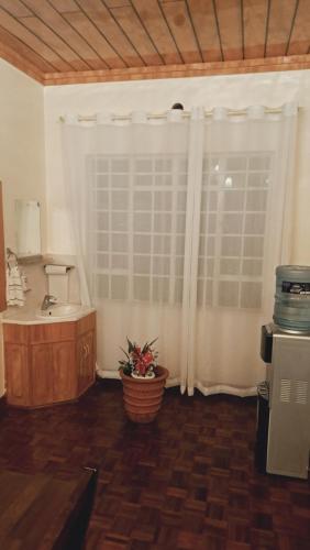 a kitchen with a window with a sink and a tub at Greenview Homes in Eldoret