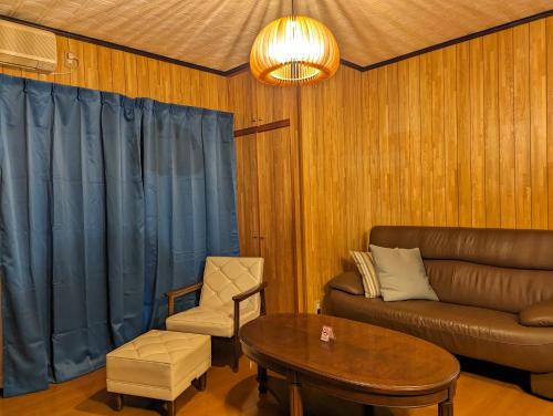 a living room with a couch and a table at 龍のお宿 in Nio