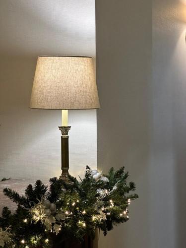 a lamp with a christmas tree on a table at TIFLIS OPERA Aparthotel in Tbilisi City