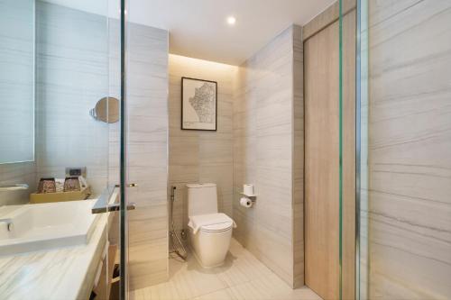 a bathroom with a toilet and a sink at Courtyard by Marriott North Pattaya in Pattaya North
