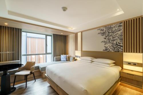 a hotel room with two beds and a desk and a window at Courtyard by Marriott North Pattaya in Pattaya North