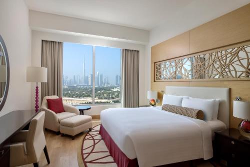 a hotel room with a large bed and a window at Marriott Executive Apartments Al Jaddaf, Dubai in Dubai