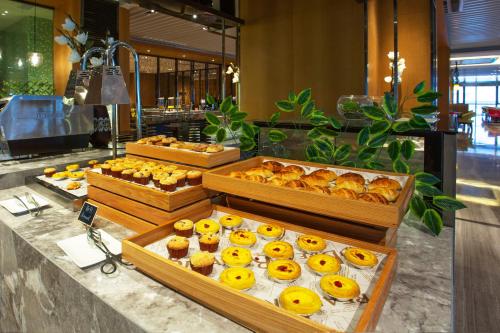 a bakery with many different types of pastries on display at Hilton Garden Inn Ningbo in Ningbo