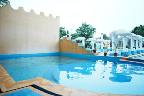 a pool at a resort with blue water at Paradise Feel Dreamy Resort in Puducherry