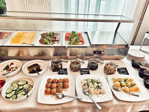 un buffet con muchos tipos diferentes de comida en una mesa en Hotel Max, en Luboń