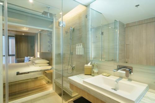 a bathroom with a sink and a shower at Courtyard by Marriott North Pattaya in Pattaya North