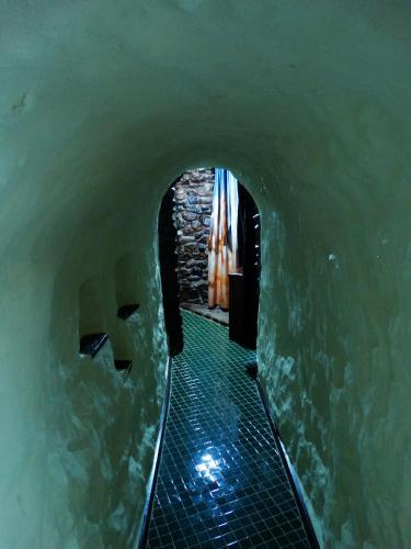 a tunnel leading into a pool of water at Di's Dugouts in Coober Pedy