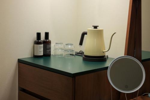 a counter with bottles of wine and glasses on it at Jeonju AANK Hotel in Jeonju