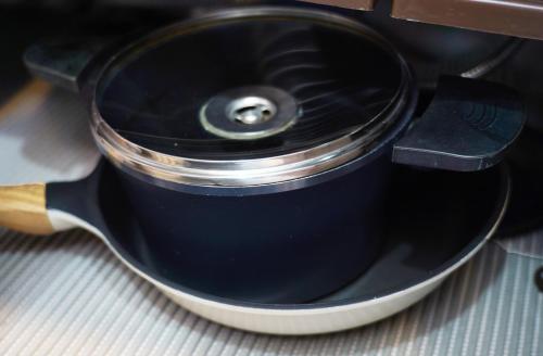 a black pot with a lid sitting on a table at Pension Haneul Tari in Jeju