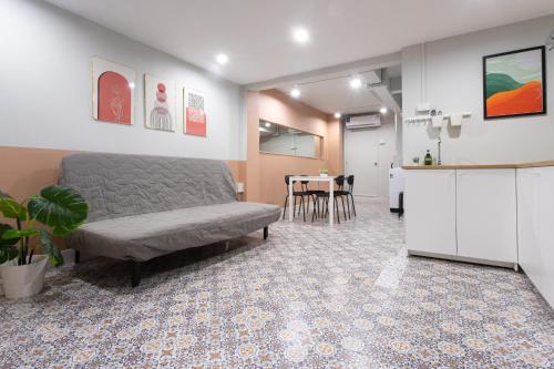a living room with a couch and a kitchen at A1 Duplex large room wt kitchen in Bangkok