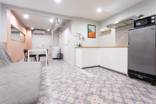 a room with a bed and a kitchen and a table at A1 Duplex large room wt kitchen in Bangkok