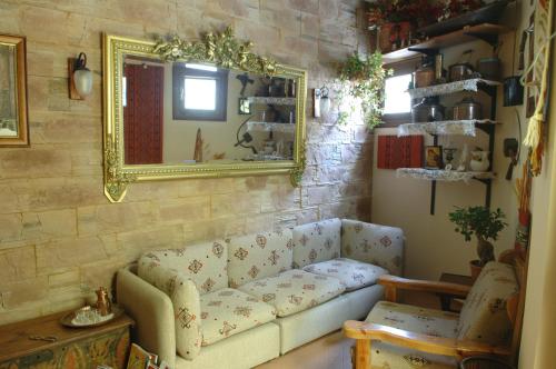a living room with a couch and a mirror at Rigas Hotel Arachova in Arachova