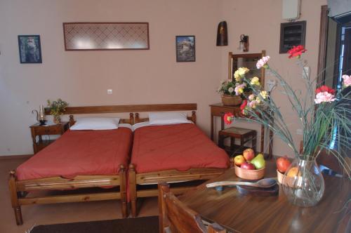 a bedroom with a bed and a table with fruit on it at Rigas Hotel Arachova in Arachova