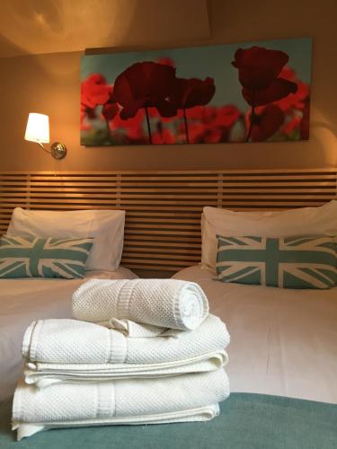 a hotel room with a bed with towels on it at Dockside Hotel in London