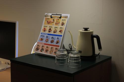 a counter with a coffee maker and glasses on it at Aank Hotel Jeonju in Jeonju
