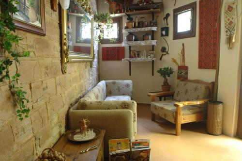 a living room with a couch and a chair and a table at Rigas Hotel Arachova in Arachova