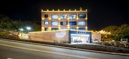 a building with lights on the side of a street at Yeosu View Foret Pension in Yeosu