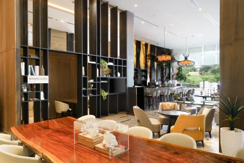 a dining room with a table and chairs at Courtyard by Marriott North Pattaya in Pattaya North