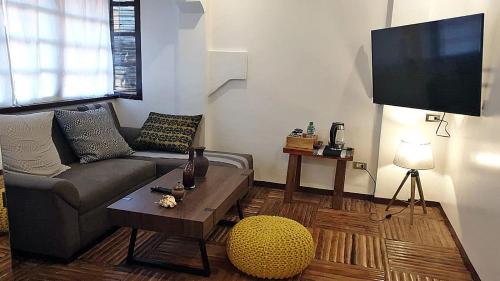 a living room with a couch and a tv at Marina 4Rooms in San Vicente