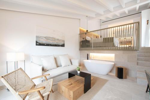a living room with a bath tub and a couch at Fincahotel Treurer - Olive Grove & Grand House - Adults Only in Algaida