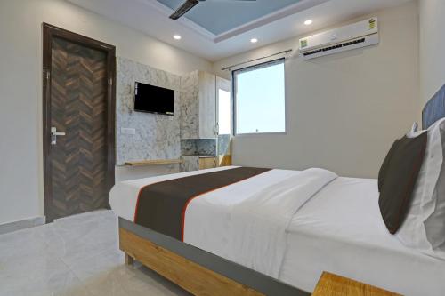 a bedroom with a large bed and a television at OYO Flagship 81411 Hotel Vip Grand in New Delhi