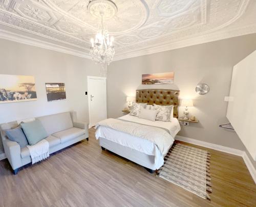 1 dormitorio con 1 cama y 1 sofá en Buffels Place, en Pretoria