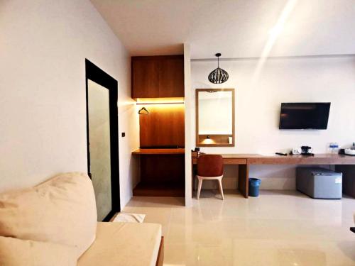 a living room with a desk and a mirror at Nana Beach Hotel & Resort in Pathiu