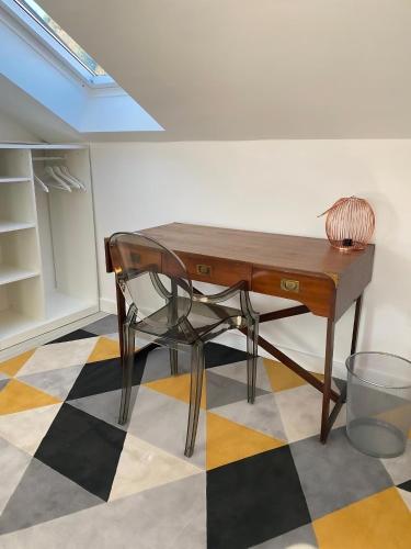 a wooden desk with a chair on a checkered floor at Adriana Zaton in Zaton