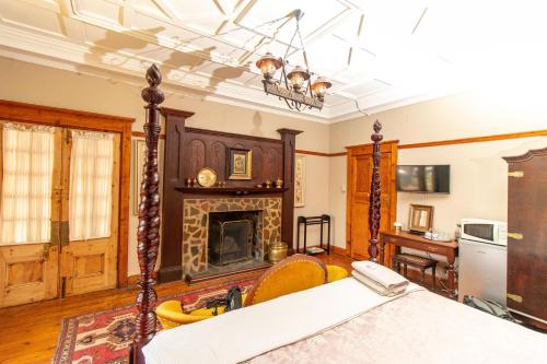 a room with a fireplace and a bed in it at Pandora's guesthouse in Bethlehem
