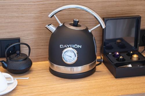 a black tea kettle on a table next to a toaster at Fincahotel Treurer - Olive Grove & Grand House - Adults Only in Algaida